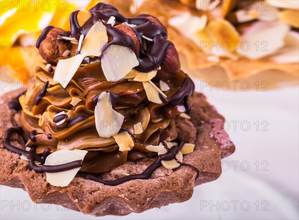 Tasty cakes on a transparent plate on a background of a white tablecloth