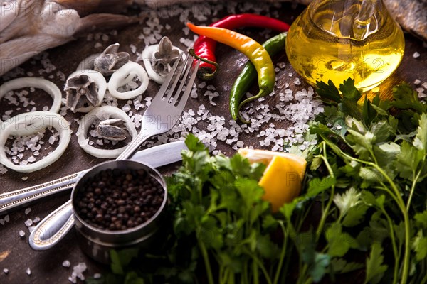 Delicious fresh fish on dark vintage background. Fish with aromatic herbs