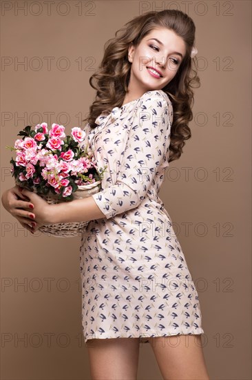 Fresh young girl in a light silk dress