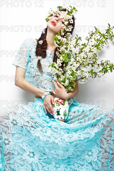 Beautiful brunette girl in blue summer dress with a gentle romantic make-up