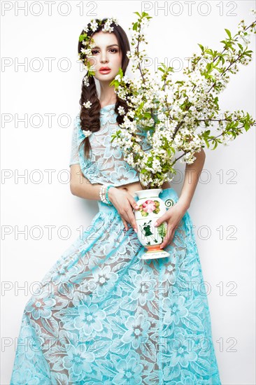 Beautiful brunette girl in blue summer dress with a gentle romantic make-up