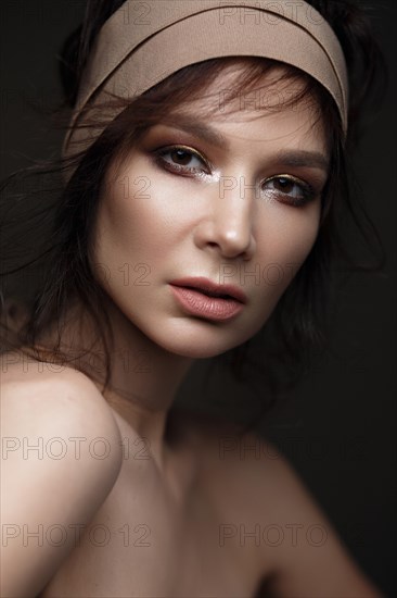 Beautiful woman with a bright make-up and perfect skin. Beauty face. Picture taken in the studio on a black background