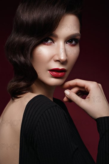 Beautiful girl in Hollywood image with wave hair and classic makeup. Beauty face. Photo taken in the studio