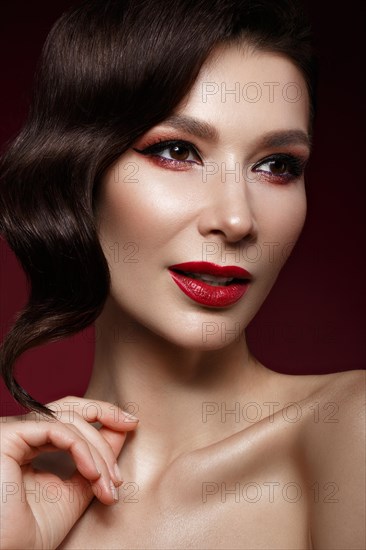 Beautiful girl in Hollywood image with wave hair and classic makeup. Beauty face. Photo taken in the studio