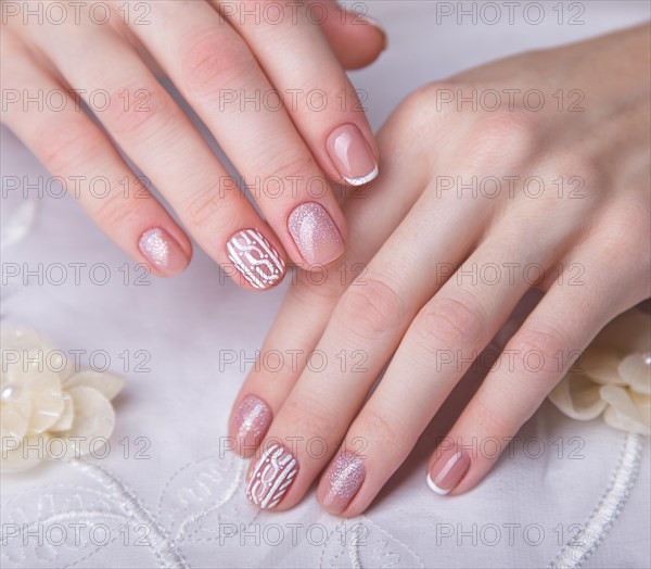 Snow White manicure on female hands. Winter nail design. Picture taken in the studio