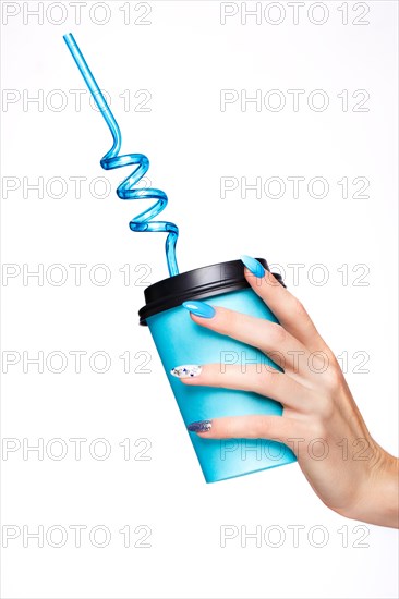 Beautiful summer blue manicure with crystals on female hand. Close-up. Picture taken in the studio