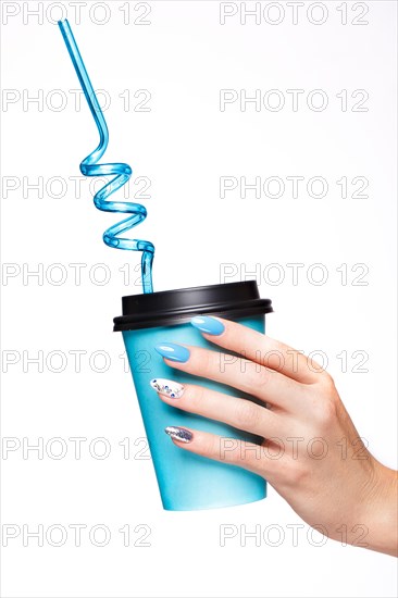 Beautiful summer blue manicure with crystals on female hand. Close-up. Picture taken in the studio