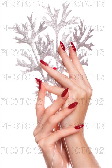 Bright festive red manicure on female hands. Nails design