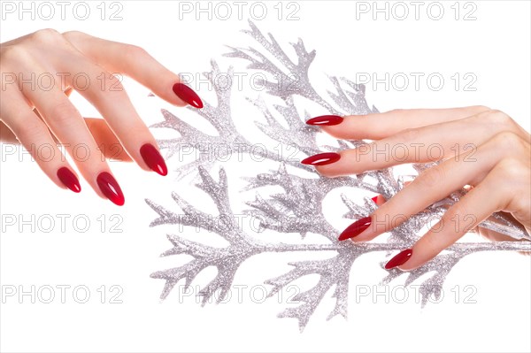 Bright festive red manicure on female hands. Nails design