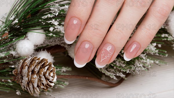 Snow White manicure on female hands. Winter nail design. Picture taken in the studio on a background of wool