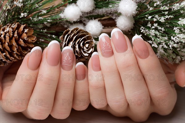 Snow White manicure on female hands. Winter nail design. Picture taken in the studio on a background of wool