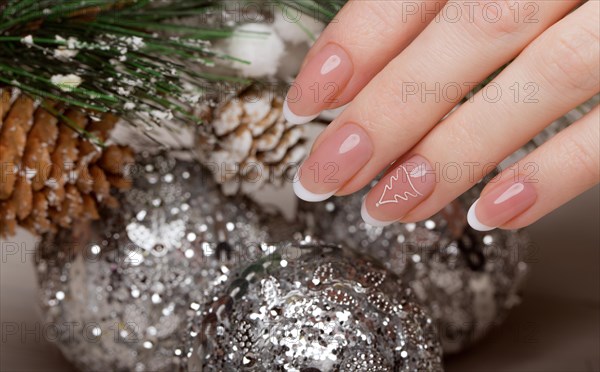 Snow White manicure on female hands. Winter nail design. Picture taken in the studio on a background of wool