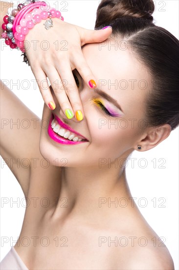 Beautiful girl in pink sunglasses with bright makeup and colorful nails. Beauty face. Picture taken in the studio on a white background