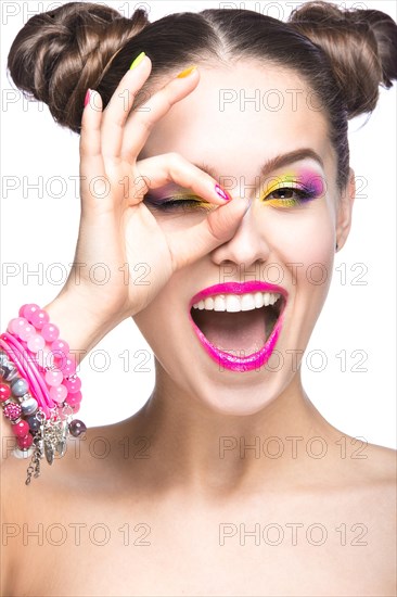 Beautiful girl in pink sunglasses with bright makeup and colorful nails. Beauty face. Picture taken in the studio on a white background