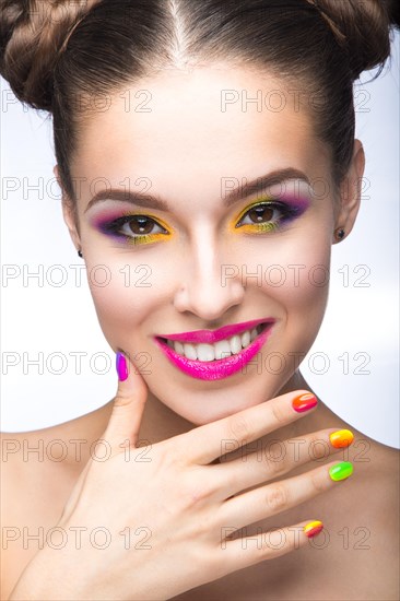 Beautiful girl in pink sunglasses with bright makeup and colorful nails. Beauty face. Picture taken in the studio on a white background
