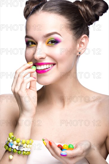 Beautiful girl in pink sunglasses with bright makeup and colorful nails. Beauty face. Picture taken in the studio on a white background