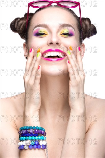 Beautiful girl in pink sunglasses with bright makeup and colorful nails. Beauty face. Picture taken in the studio on a white background