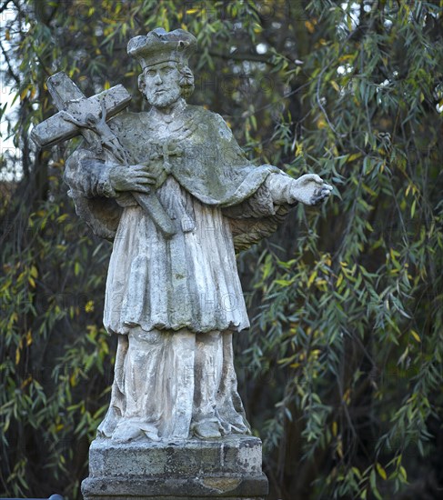 Stone sculpture of Saint Nepomuk on a bridge