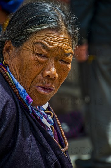 Old tibetan woman before the Jokhang temple