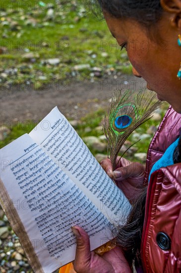 Student writing with a peasant feather