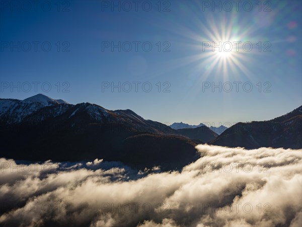 Mountains of the Salzkammergut and Tennengebirge above the sea of clouds in sunshine