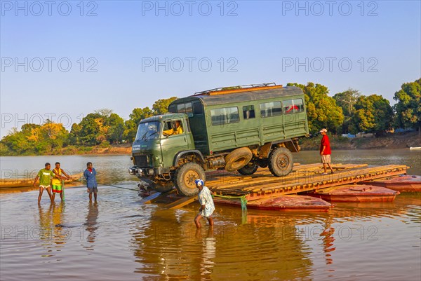 Truck crossing on a improvised ferry the Manambolo river