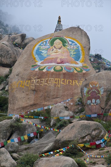 Huge Buddha painted on a rock behind the Drepung temple