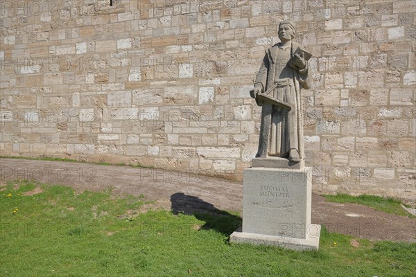 Monument and statue by Thomas Muenzter with book