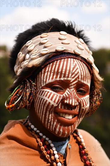 Kikuyu woman with face paint poses for photographers at Nyahururu Falls