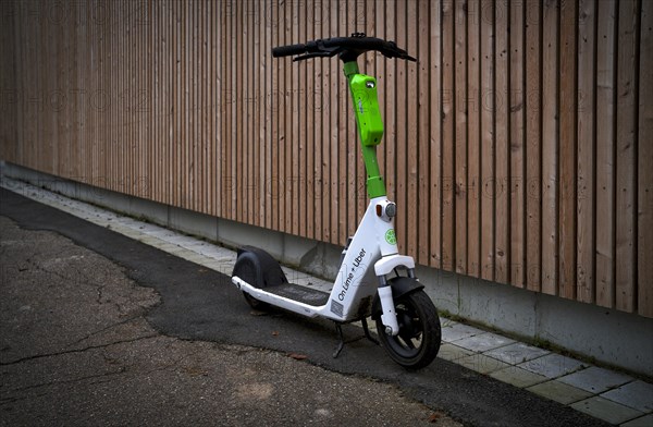 E-scooter parked on the side of the road in the bike rental of the company Lime