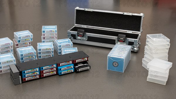 Data backup magnetic tapes lie next to a lockable transport case