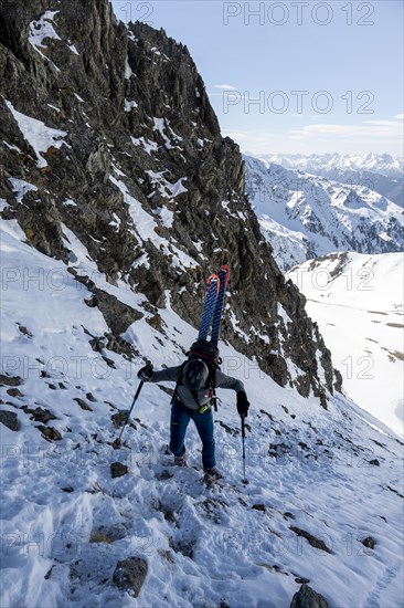 Ski tourers on the ascent in a saddle