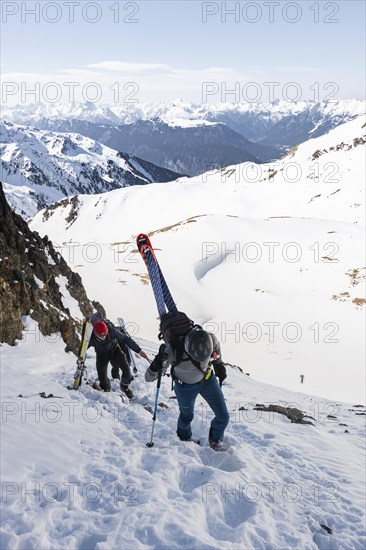 Ski tourers on the ascent in a saddle