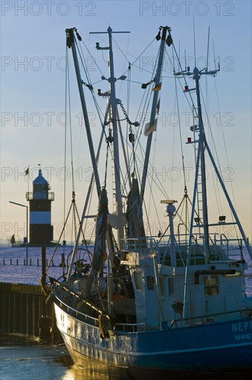 Port of Wremertief in winter with the lighthouse Kleiner Preusse