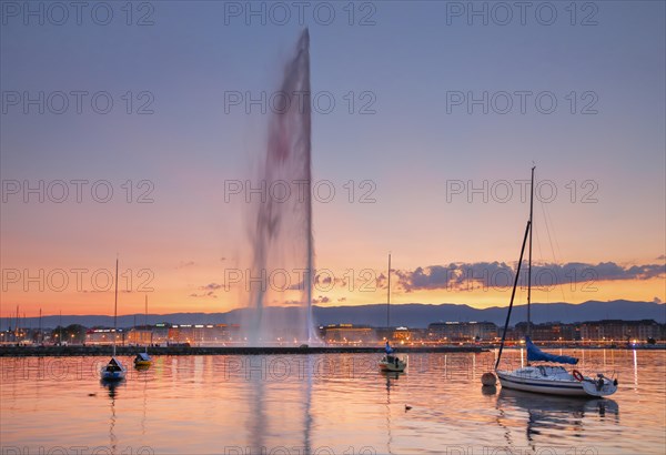 The Jet d'eau at dusk is the landmark in Geneva's harbour basin