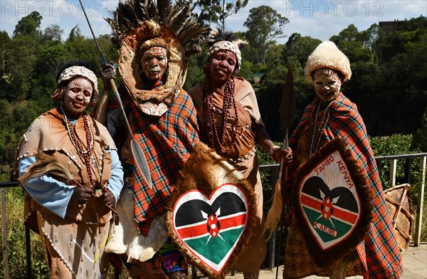 Kikuyu dancer with face paint poses for photographers at Nyahururu Falls