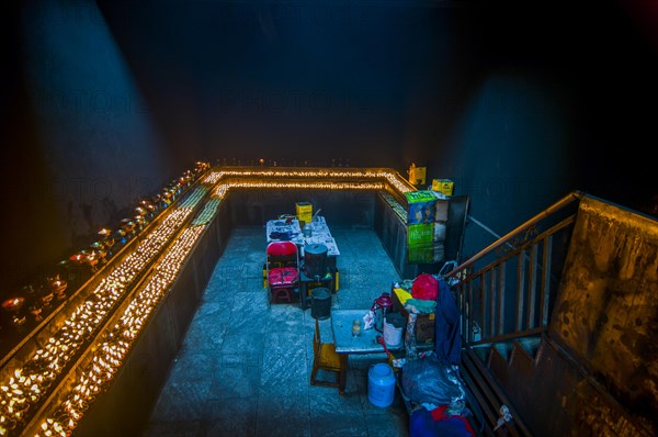 Dark room with many candles in the Ramoche temple