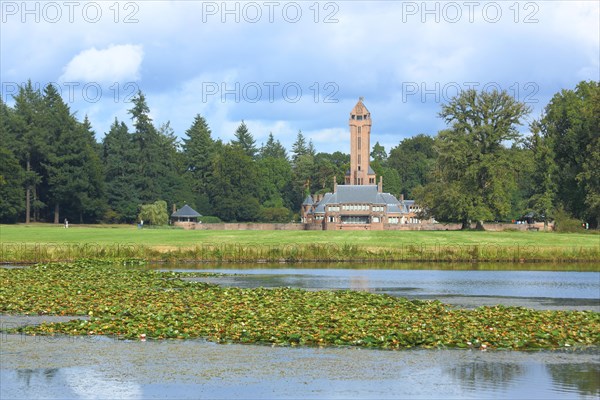 View of Jachthuis Sint Hubertus built 1915 on the lake with pond roses