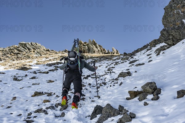 Ski tourers on the ascent in a saddle