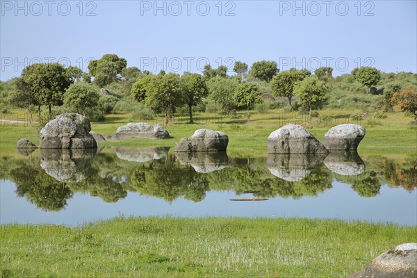 Landscape with rock formation and reflection in the lake shore
