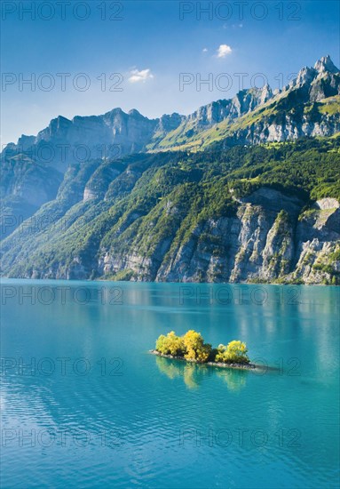 Aerial view of Lake Walen with a view of Chive Island in the turquoise water and Leistchamm and Churfirsten in the background