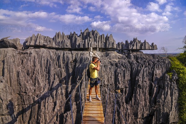Man on a hanging bridge in the Tsingys