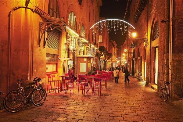 Street cafe in the pedestrian zone with Christmas lights