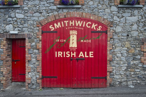 Red painted gate to a beer warehouse