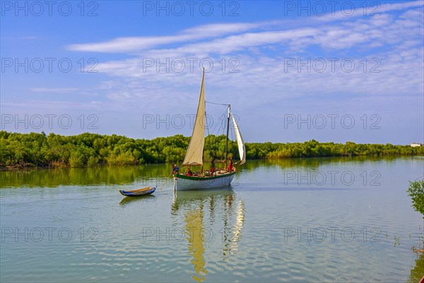 Little sailing boat shipping on a side arm