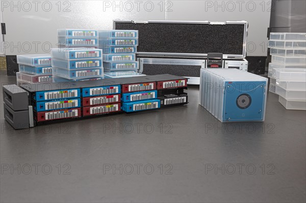 Data backup magnetic tapes lie next to a lockable transport case