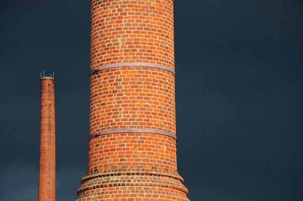 Factory chimney in front of storm clouds