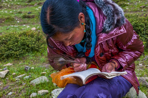 Student writing with a peasant feather