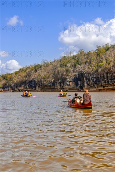 Tourists sitting in boats on the Tsiribina river