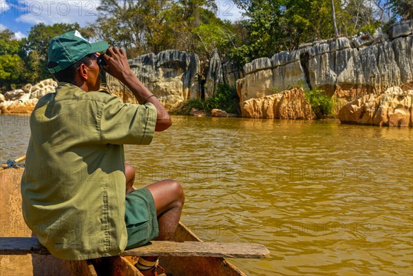 Guide sitting on a boat in the Tsiribina river